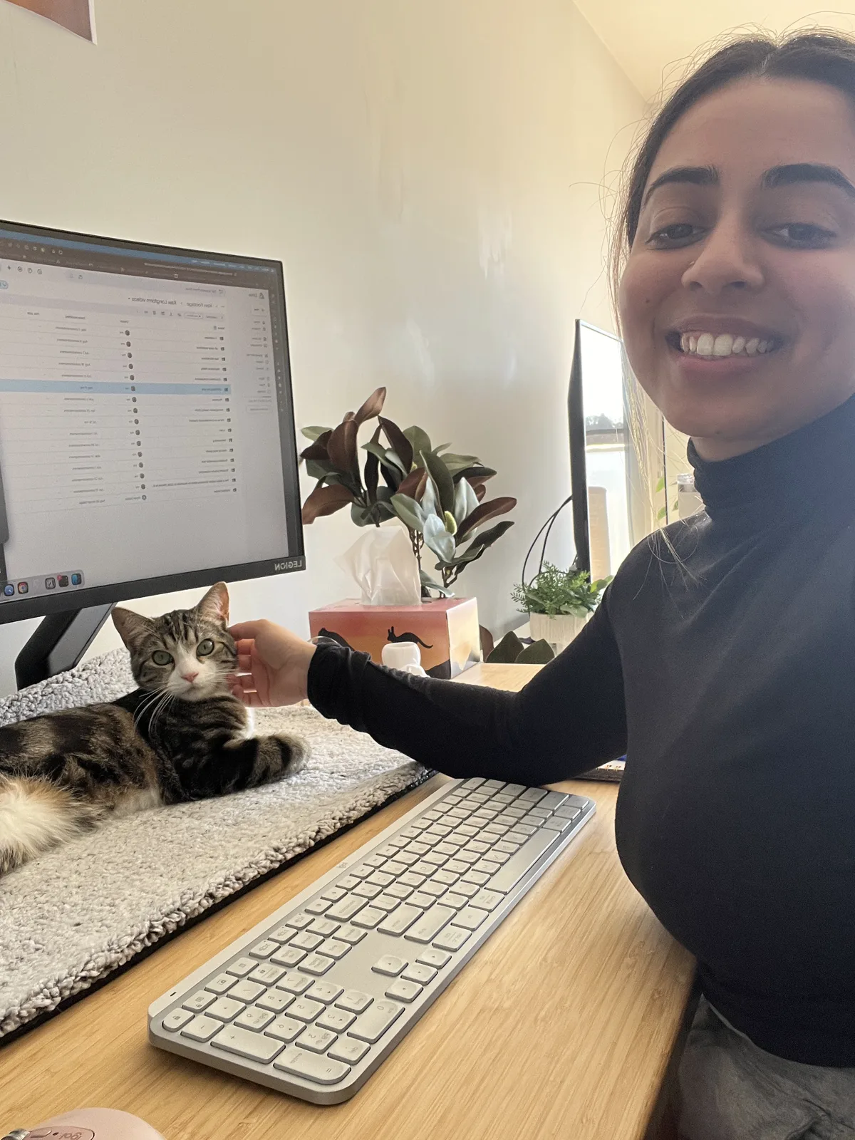 Priyanka at her home desk with her cat
